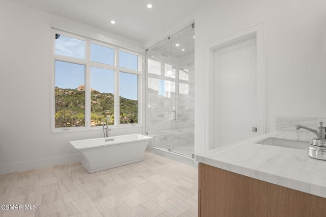 bathroom featuring vanity and separate shower and tub