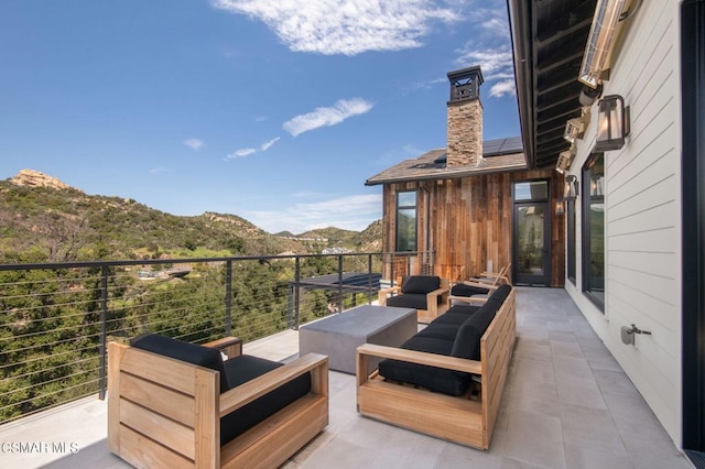 view of patio / terrace featuring a mountain view and an outdoor hangout area