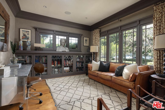 living room featuring crown molding, a healthy amount of sunlight, and hardwood / wood-style flooring