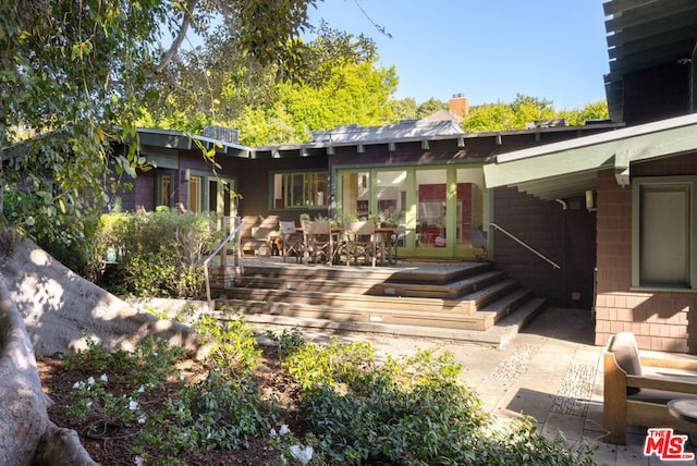 back of house with a wooden deck