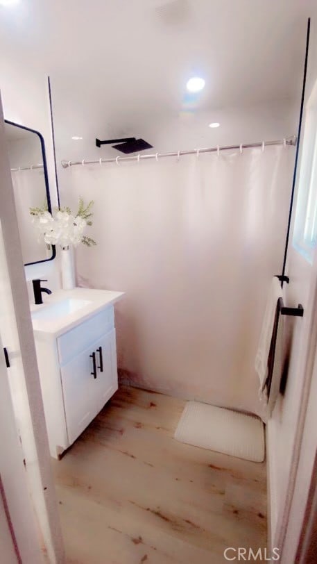 bathroom featuring vanity and hardwood / wood-style flooring