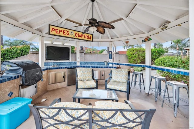 view of patio / terrace with a gazebo, exterior bar, a grill, and ceiling fan