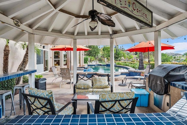 view of patio with a gazebo, ceiling fan, and grilling area