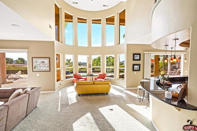 living room featuring a high ceiling and light carpet