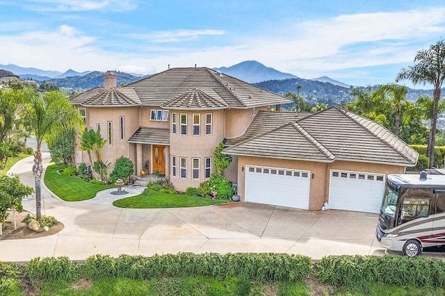 view of front of property featuring a mountain view and a garage