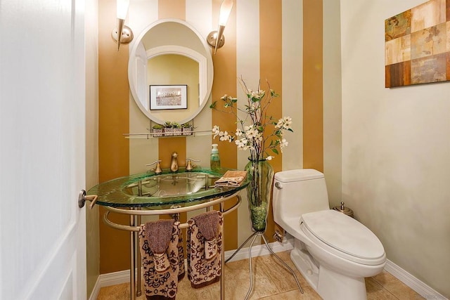 bathroom featuring sink, toilet, and tile patterned flooring