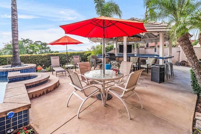 view of patio with an in ground hot tub