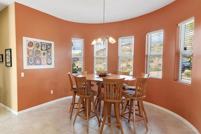 tiled dining room featuring a notable chandelier