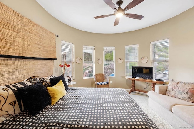 bedroom featuring ceiling fan, carpet, and multiple windows