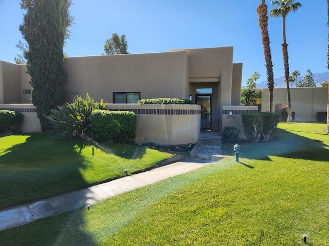 southwest-style home with a front lawn