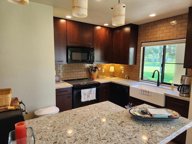 kitchen featuring black appliances, backsplash, sink, and dark brown cabinetry