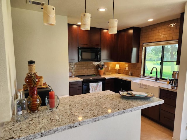 kitchen with dark brown cabinets, decorative light fixtures, kitchen peninsula, and black appliances