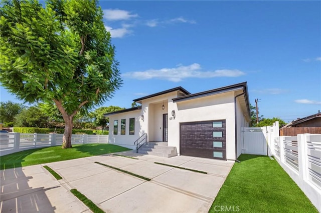 view of front of house with a garage and a front yard