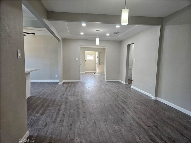 unfurnished room with ceiling fan and dark wood-type flooring