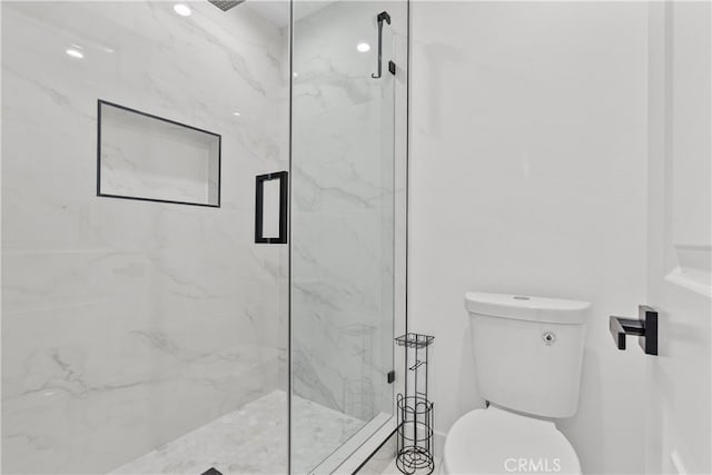 bathroom with toilet and walk in shower