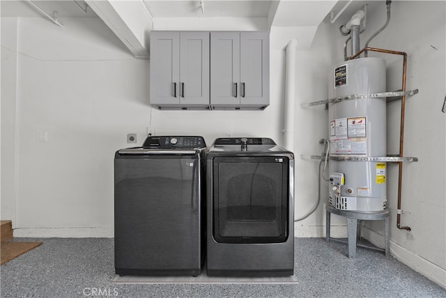 laundry area featuring cabinets, water heater, and washing machine and clothes dryer