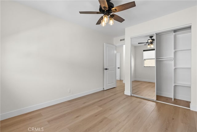 unfurnished bedroom with a closet, ceiling fan, and light hardwood / wood-style floors