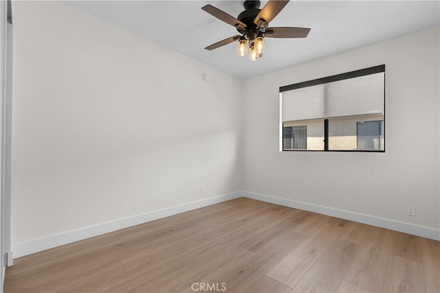 spare room with light wood-type flooring and ceiling fan