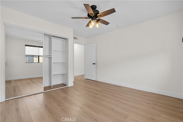 unfurnished bedroom with a closet, ceiling fan, and light hardwood / wood-style floors