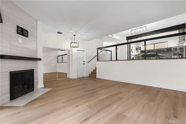 unfurnished living room featuring light hardwood / wood-style flooring and a fireplace