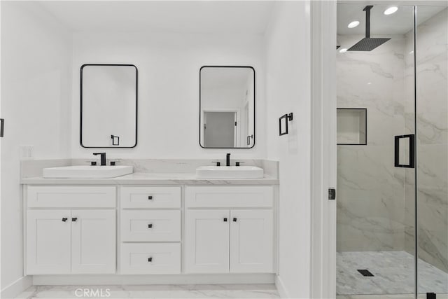 bathroom featuring vanity and an enclosed shower