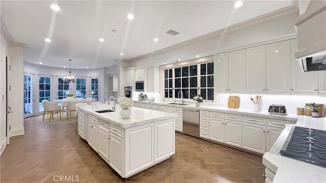 kitchen featuring white cabinetry, stainless steel appliances, and a kitchen island with sink