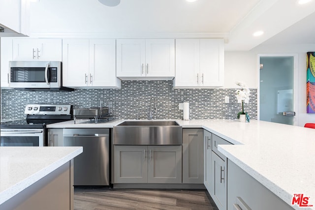 kitchen with sink, white cabinetry, appliances with stainless steel finishes, and gray cabinets