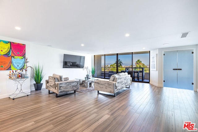 living room with expansive windows and wood-type flooring