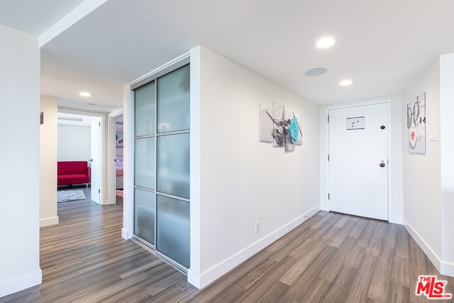 hallway with dark wood-type flooring