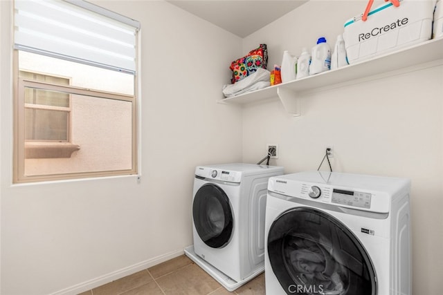 laundry room featuring washer and clothes dryer and light tile patterned floors