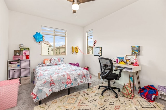 bedroom with ceiling fan and light carpet