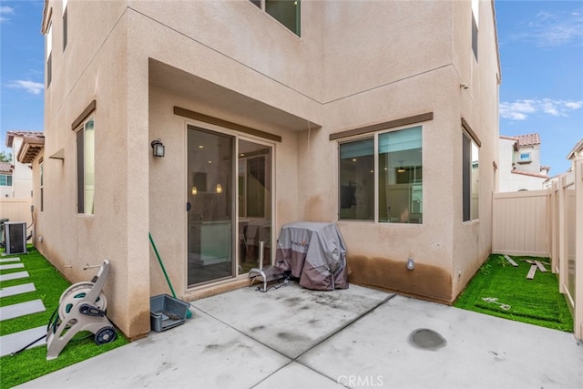 back of property featuring a lawn and a patio