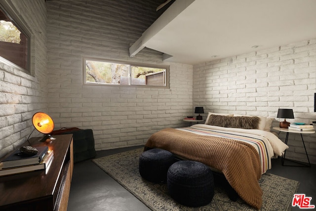 bedroom featuring brick wall