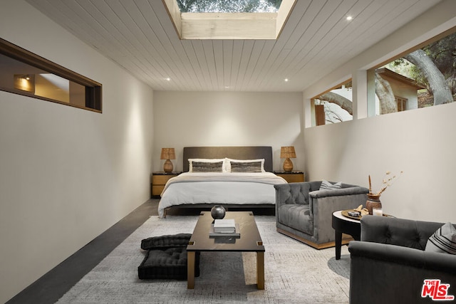 bedroom with wood ceiling and a skylight