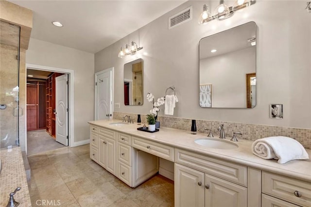 bathroom featuring tile patterned floors, vanity, and a shower with shower door