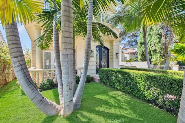 entrance to property featuring a lawn