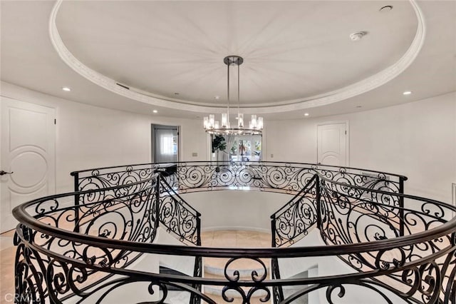 interior space with an inviting chandelier and a raised ceiling