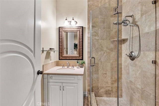 bathroom featuring vanity and a shower with shower door