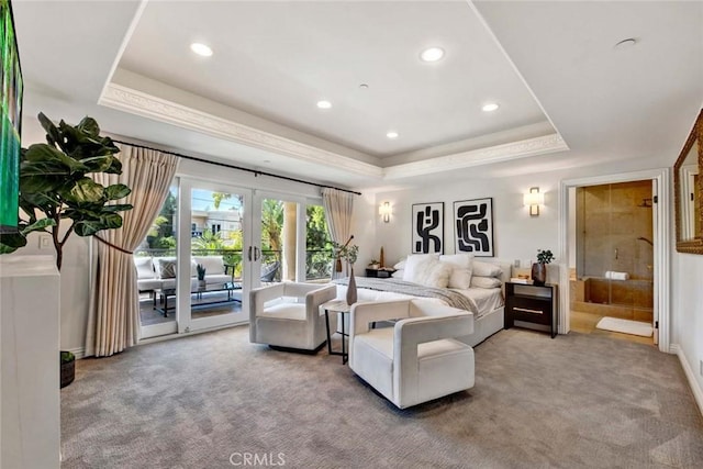 carpeted bedroom with access to outside, french doors, and a tray ceiling