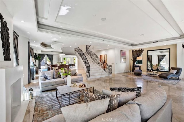 living room with a raised ceiling and a healthy amount of sunlight