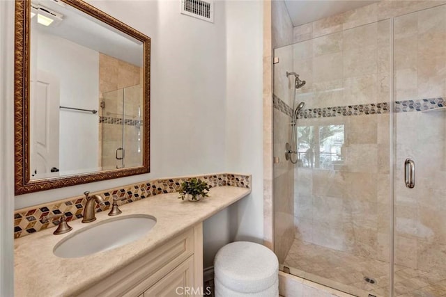 bathroom with vanity and a shower with shower door