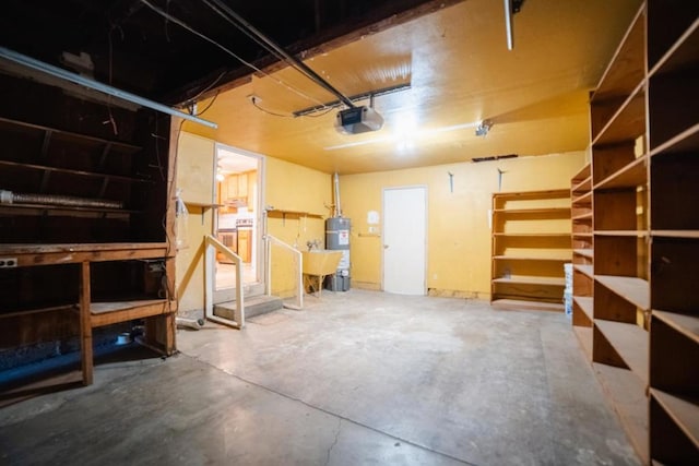 garage featuring strapped water heater and a garage door opener