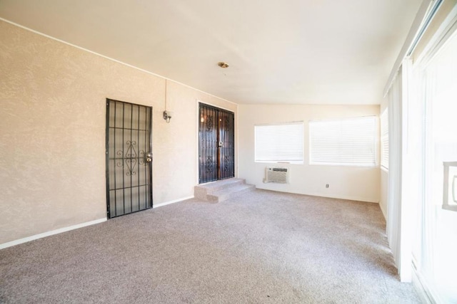 carpeted empty room featuring a wall mounted air conditioner and vaulted ceiling