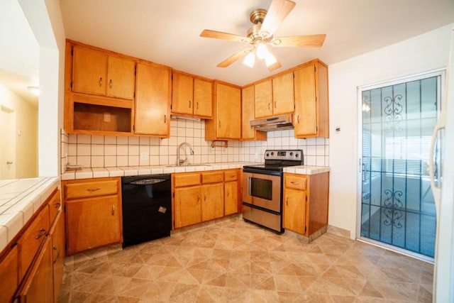 kitchen with ceiling fan, dishwasher, sink, tile countertops, and stainless steel range with electric cooktop