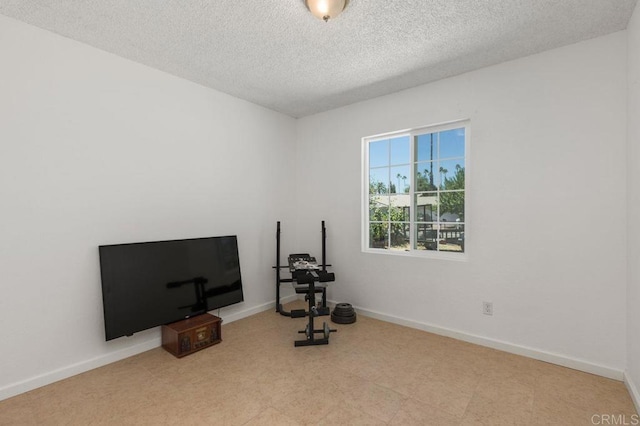 exercise room with a textured ceiling