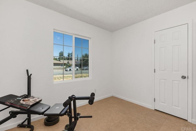 exercise area with a textured ceiling