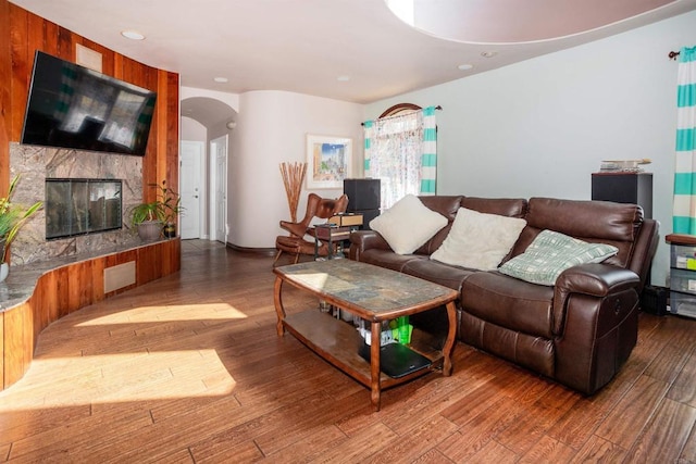 living room featuring hardwood / wood-style floors and a high end fireplace