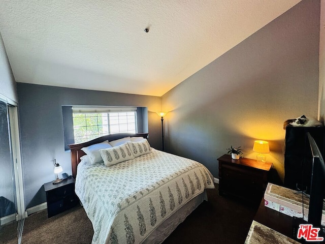 carpeted bedroom with a textured ceiling