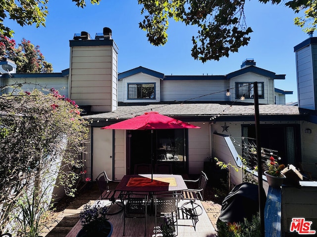 rear view of property featuring a patio area