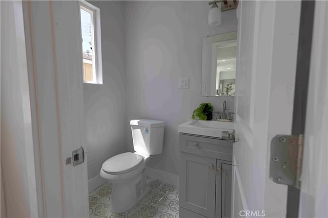 bathroom with vanity, toilet, and tile patterned flooring